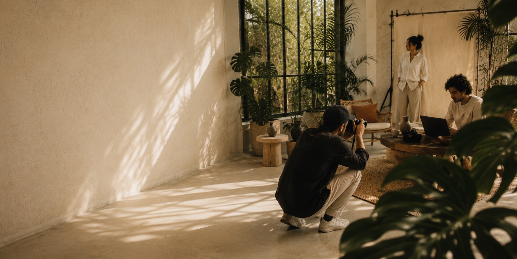 A Tropical Photography shoot in progress in a sunlit, plant-filled studio